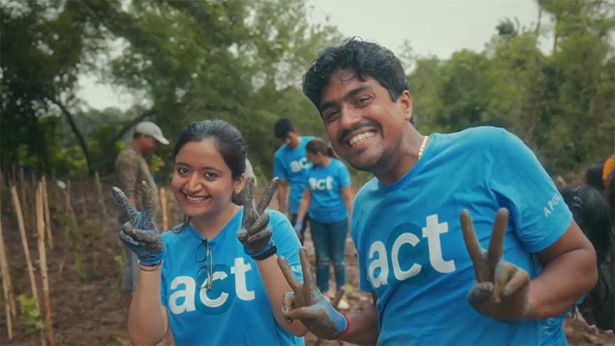 Volunteers from Apollo participate in community service during Summer ACT 2023; two individuals take a photo while others engage in social work, reflecting Apollo’s commitment to expanding opportunity.