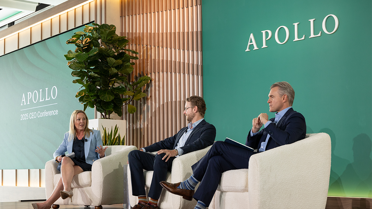 Three Apollo executives seated in white armchairs onstage at the 2025 CEO Conference, engaged in a panel discussion with branded green backdrop and APOLLO signage.