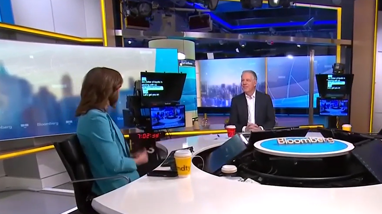 Jim Zelter, President of Apollo Global Management, speaks on Bloomberg Surveillance about AI-driven capital expenditure and credit market trends, seated in a broadcast studio with NYC skyline in background.